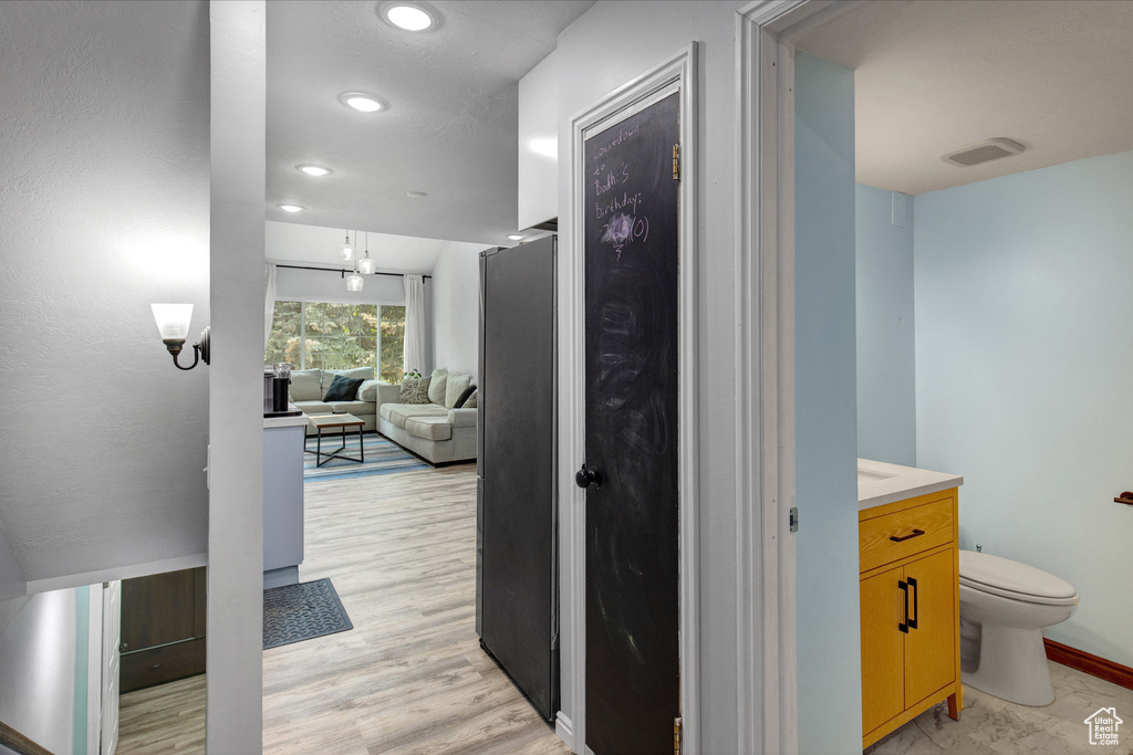 Corridor with recessed lighting and light wood-style flooring