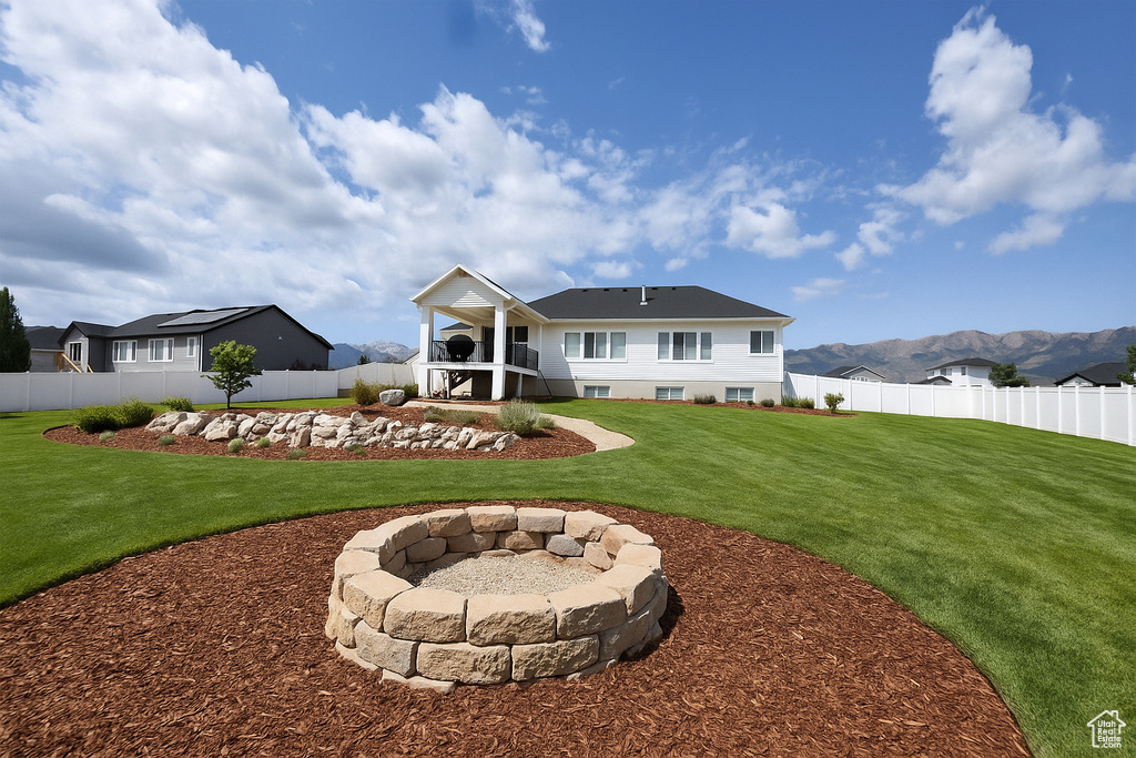 Rear view of house featuring an outdoor fire pit and stairway