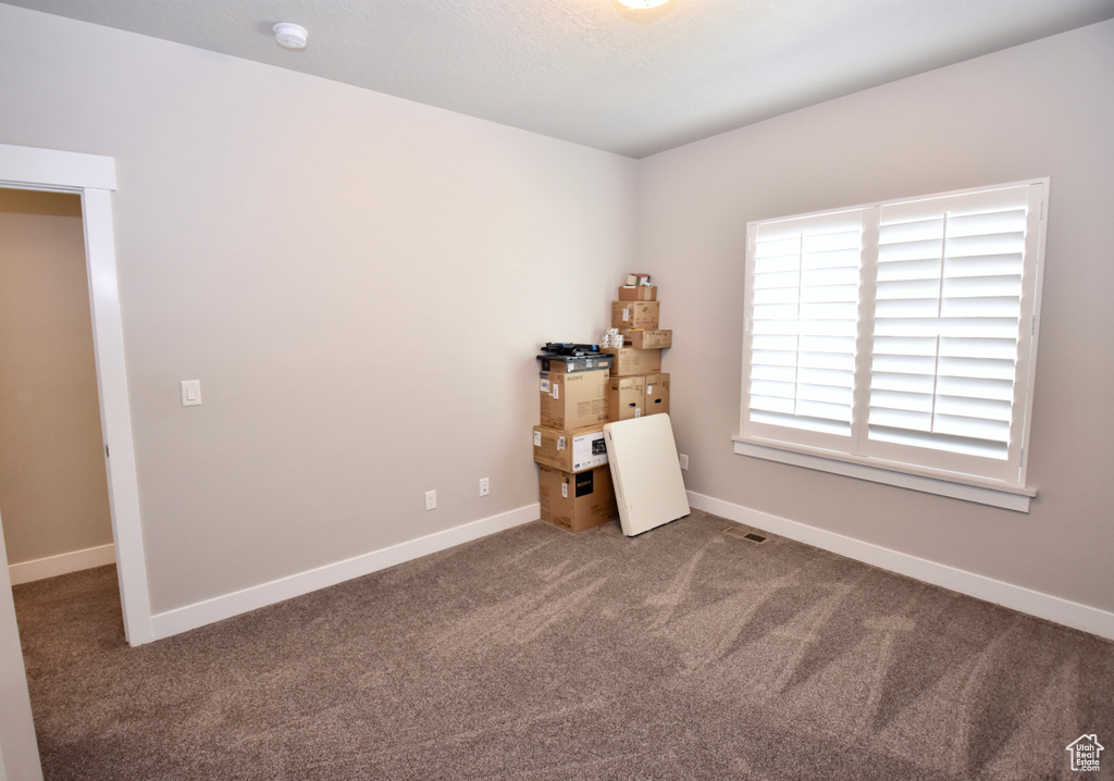 Carpeted bedroom with baseboards
