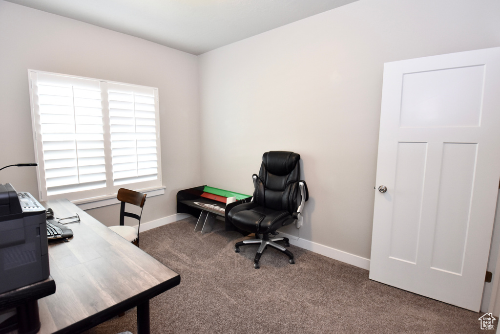 Carpeted office space featuring baseboards