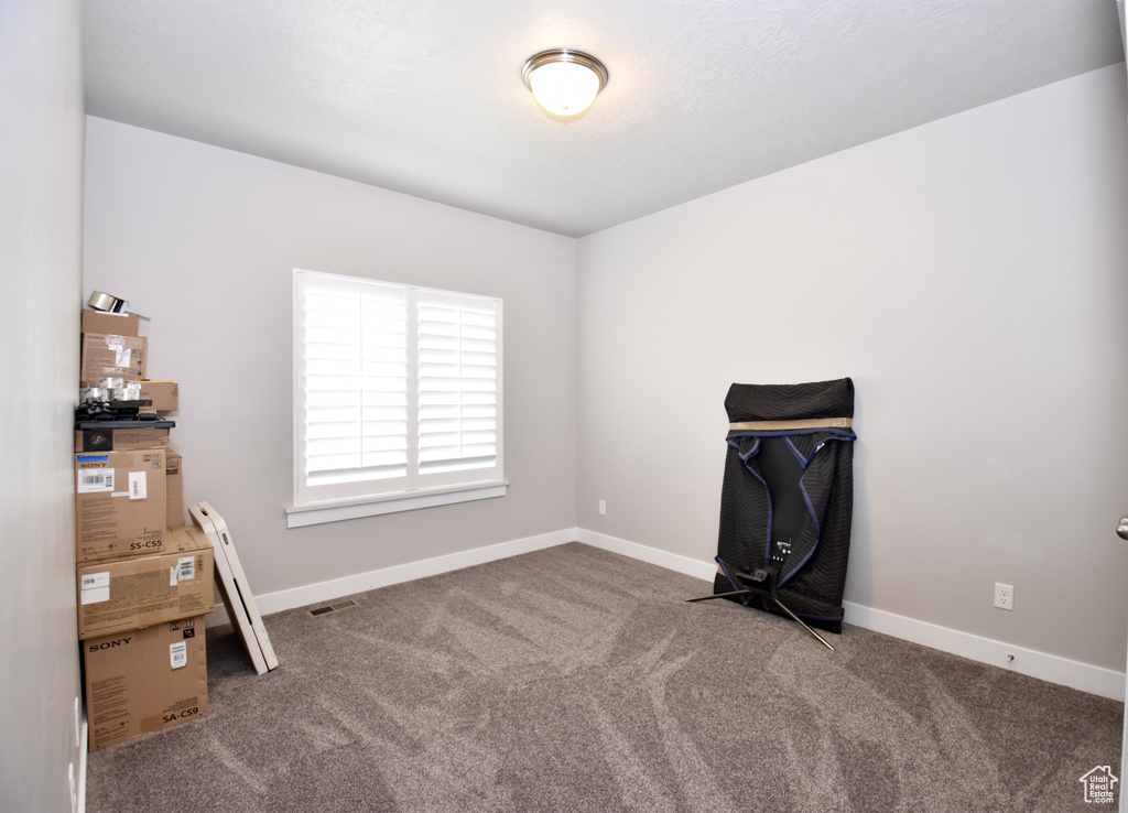 Misc room featuring carpet and baseboards