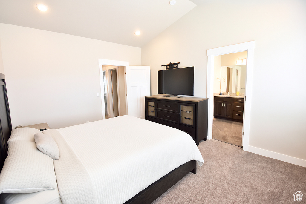 Bedroom featuring light colored carpet, lofted ceiling, baseboards, ensuite bathroom, and recessed lighting