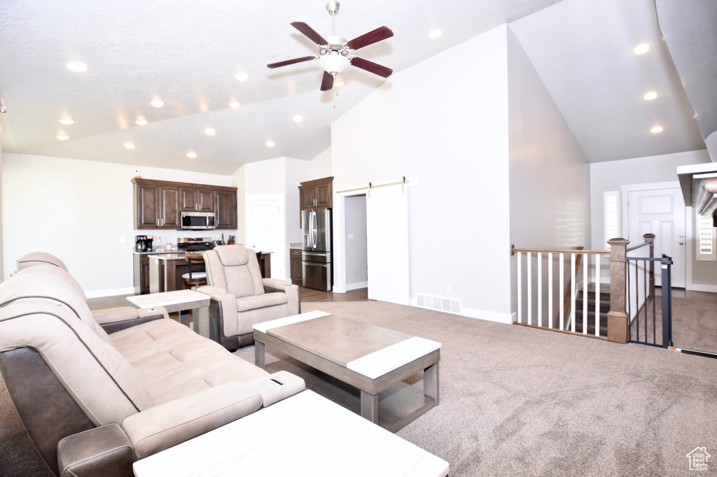 Living room featuring ceiling fan, recessed lighting, baseboards, high vaulted ceiling, and light colored carpet