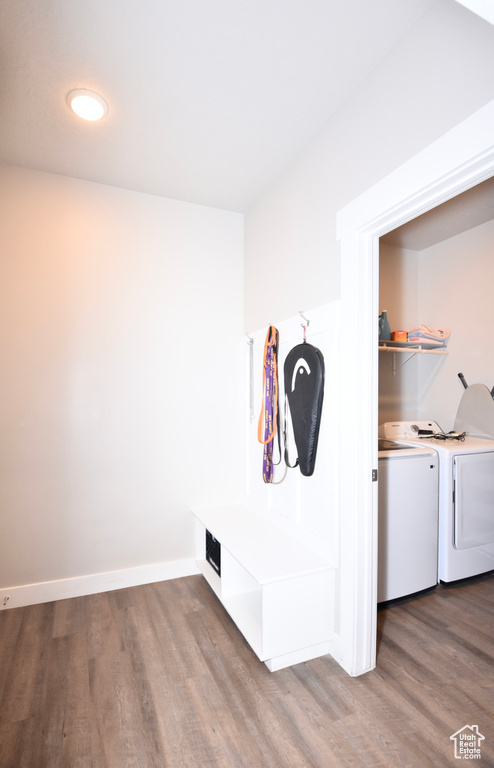Mudroom with independent washer and dryer, wood finished floors, and baseboards