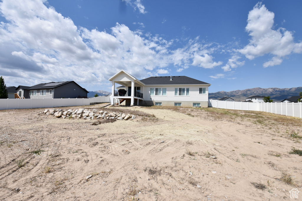Back of property with a mountain view