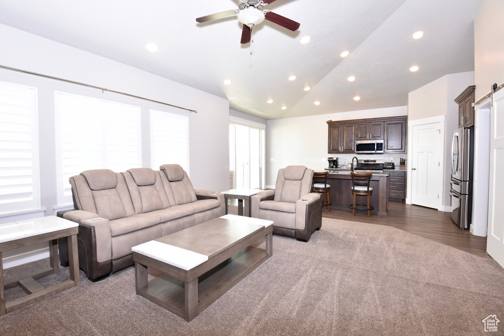 Living area with recessed lighting, lofted ceiling, a ceiling fan, and wood finished floors