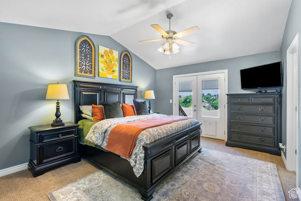 Bedroom featuring light colored carpet, access to outside, lofted ceiling, and ceiling fan