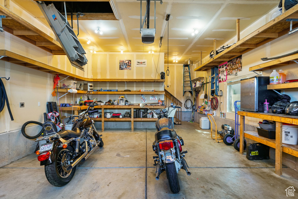 Garage featuring a workshop area and a garage door opener