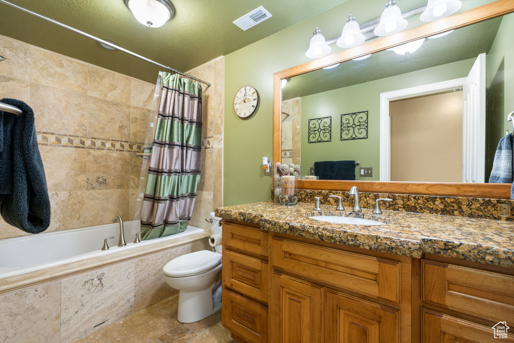 Full bathroom with vanity and tiled shower / bath combo
