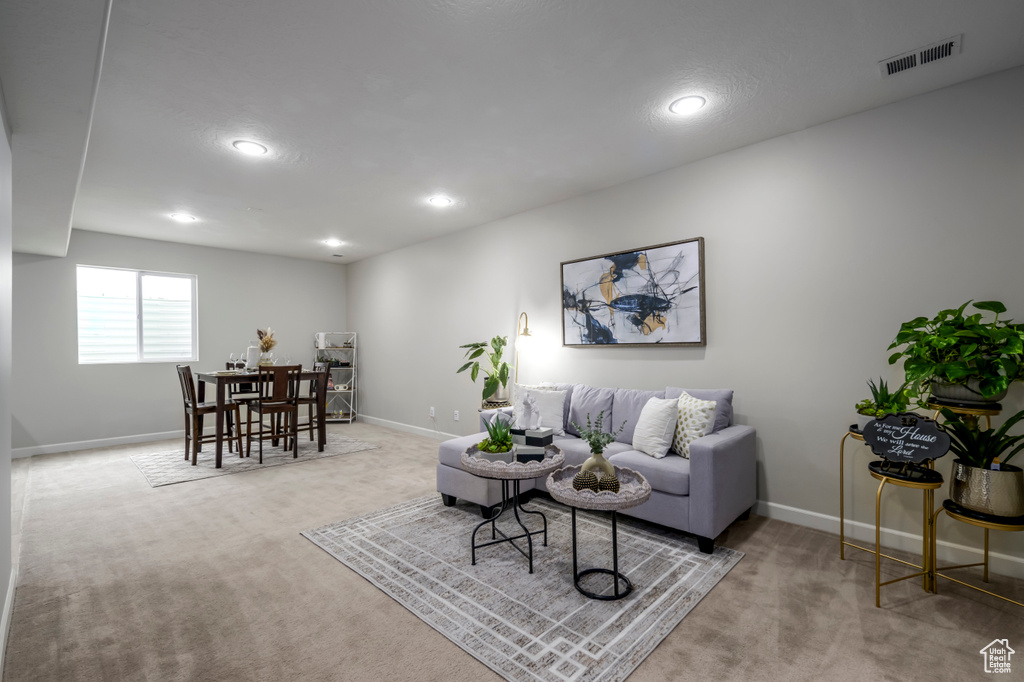 Living room with carpet floors, recessed lighting, and baseboards