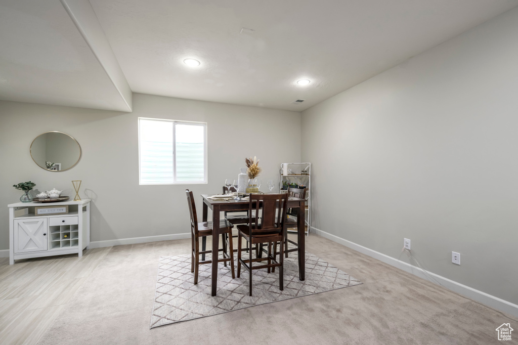 Dining area featuring baseboards, light colored carpet, and recessed lighting