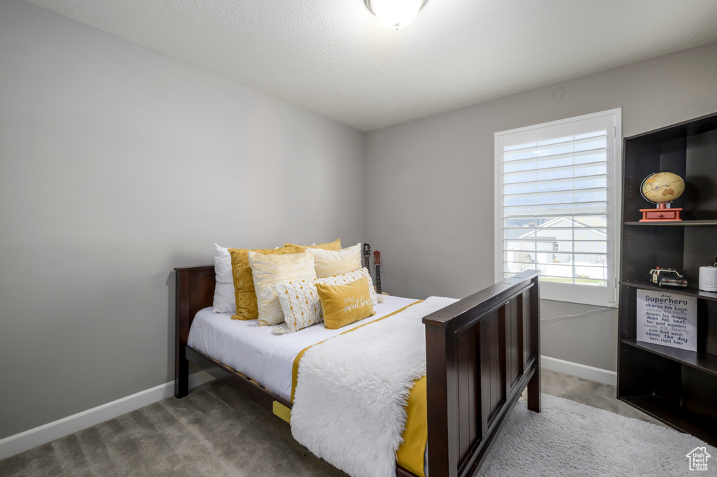 Carpeted bedroom with baseboards