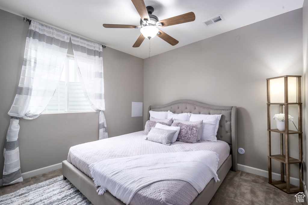 Bedroom featuring carpet, baseboards, and ceiling fan