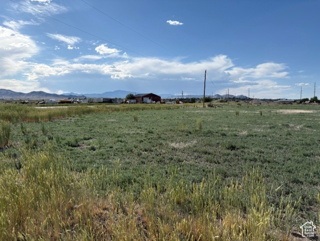 View of undeveloped land featuring rural landscape and mountains