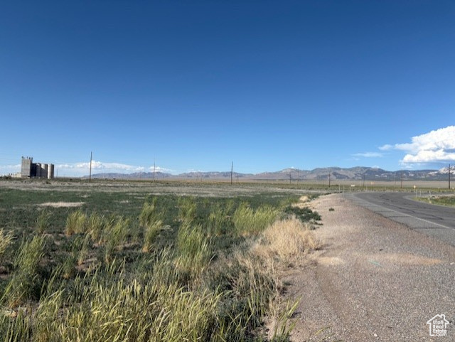 View of asphalt street with a mountain view and a view of rural / pastoral area