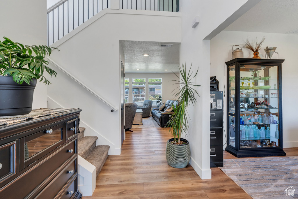 Entrance foyer featuring stairway and light wood finished floors