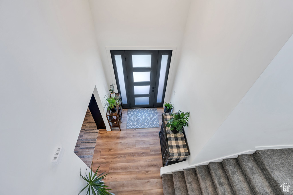 Entrance foyer with stairway and wood finished floors