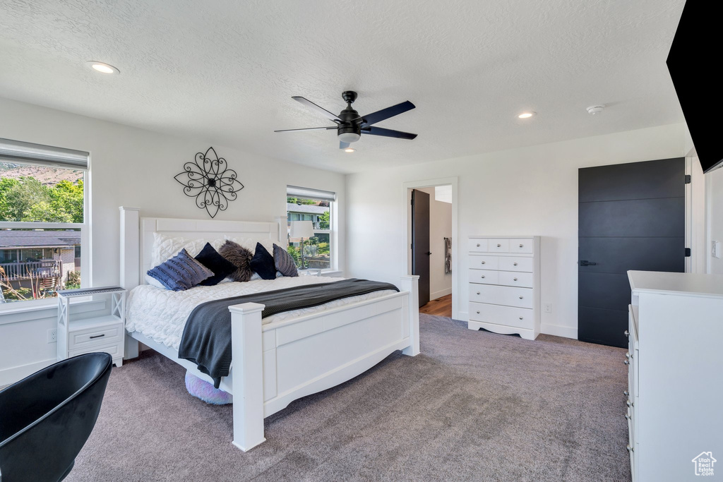 Bedroom featuring multiple windows, carpet, a textured ceiling, recessed lighting, and ceiling fan