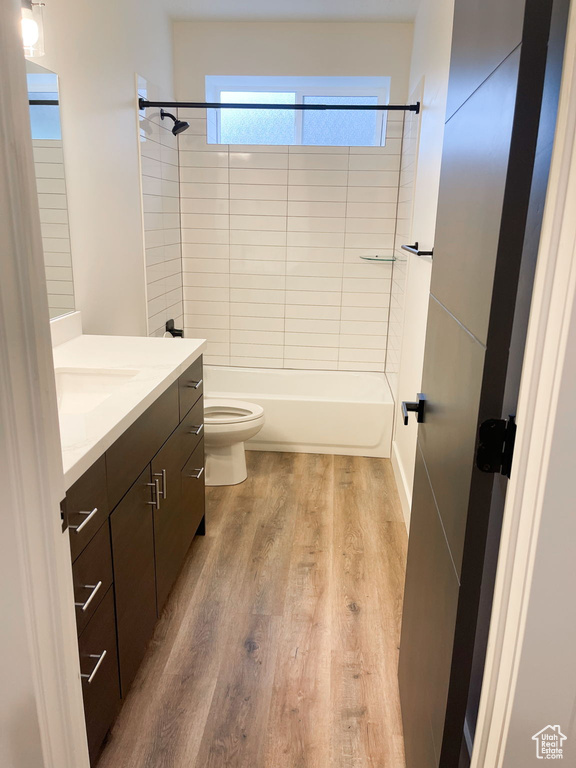 Full bathroom featuring vanity, wood finished floors, and shower / washtub combination