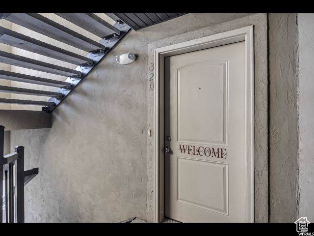 Property entrance with stucco siding