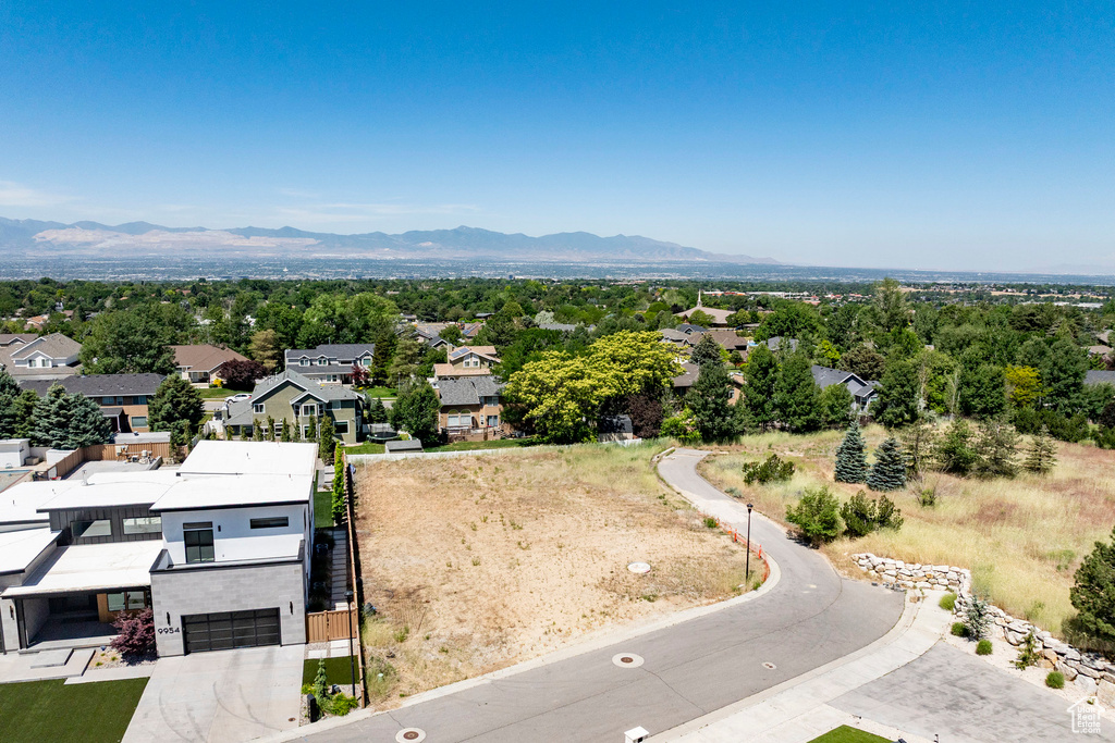 Aerial perspective of suburban area featuring a mountainous background