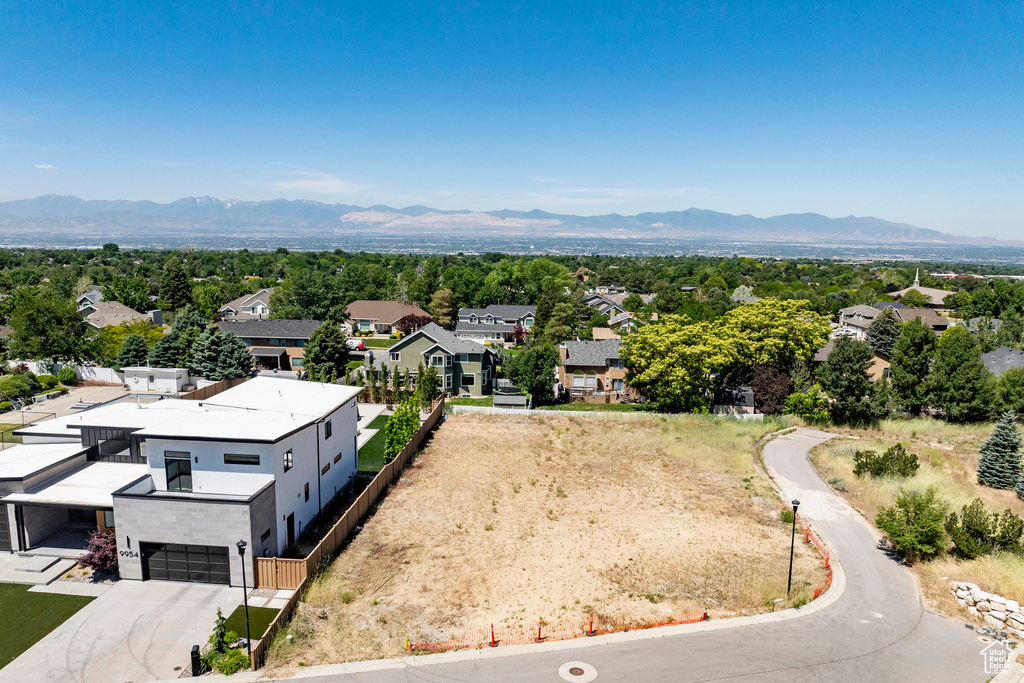 Aerial view of residential area featuring a mountainous background