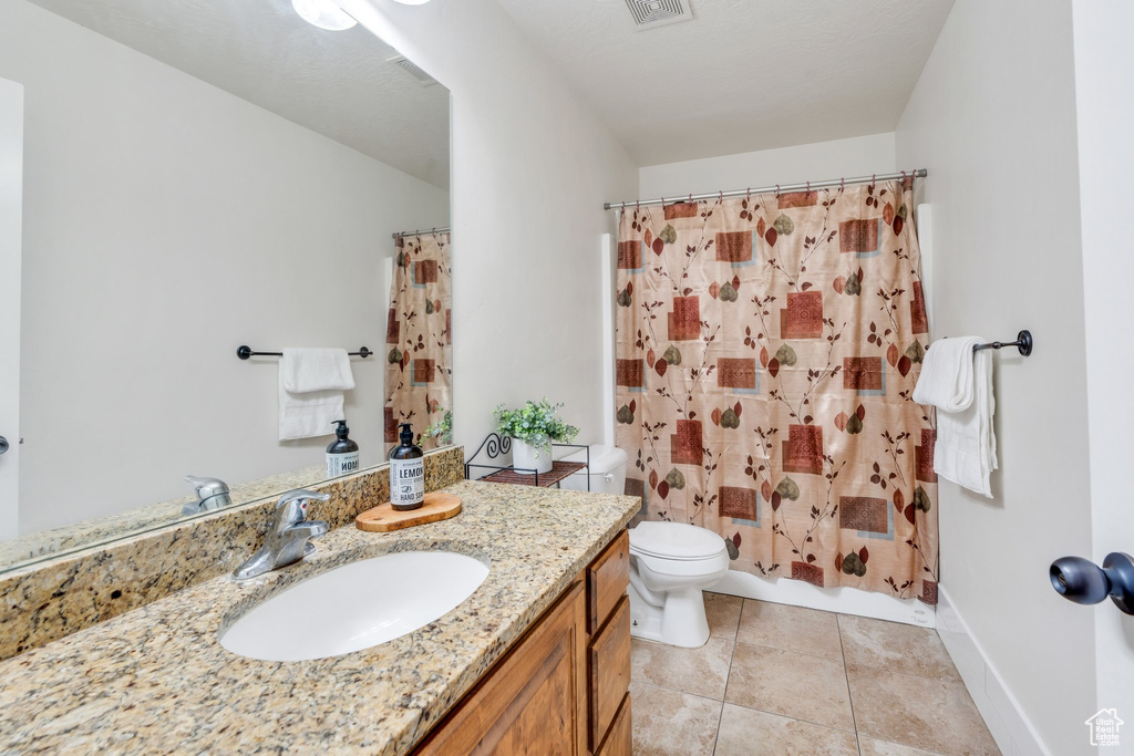 Bathroom featuring vanity and tile patterned floors