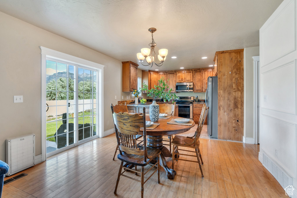 Dining room featuring a chandelier, recessed lighting, and light wood-type flooring