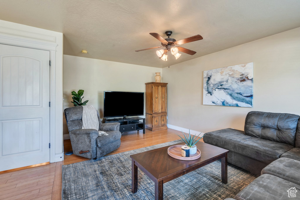 Living room with wood finished floors and ceiling fan