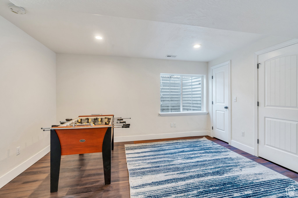 Playroom with dark wood-style flooring and recessed lighting