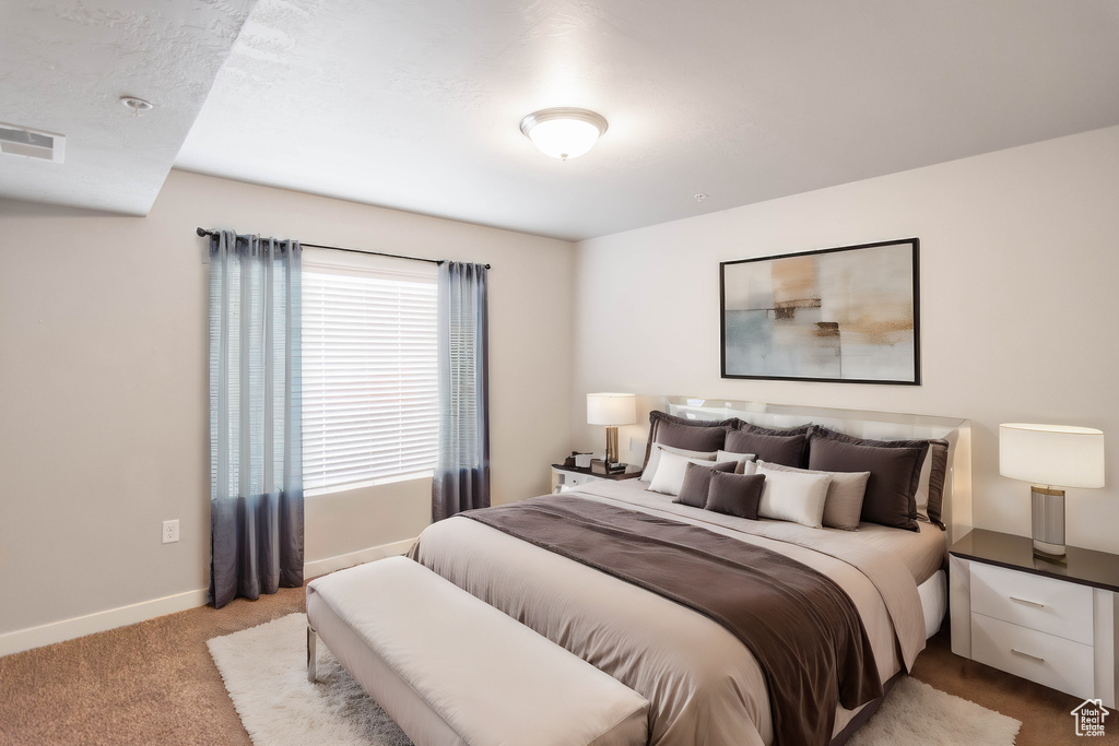 Carpeted bedroom featuring baseboards