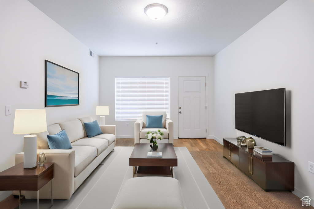 Living room with baseboards and light wood finished floors