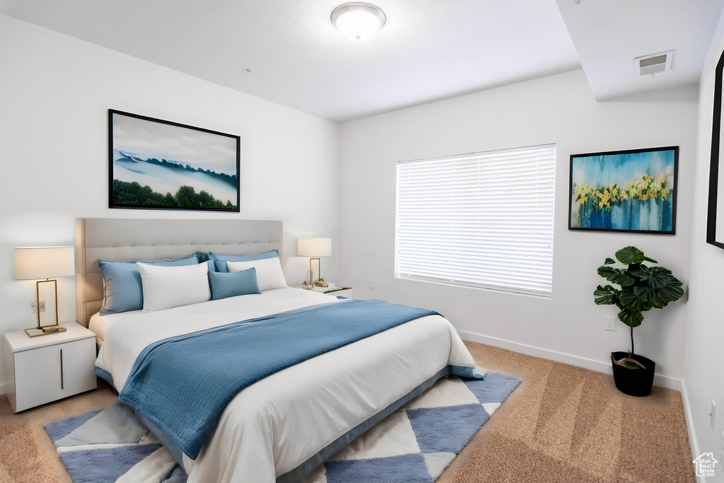 Bedroom with light carpet