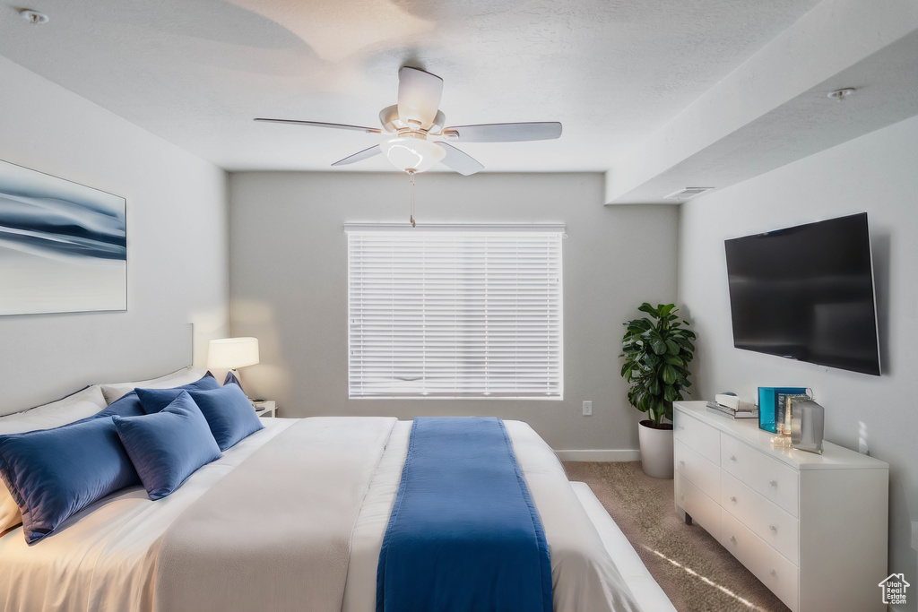 Bedroom with light carpet and ceiling fan