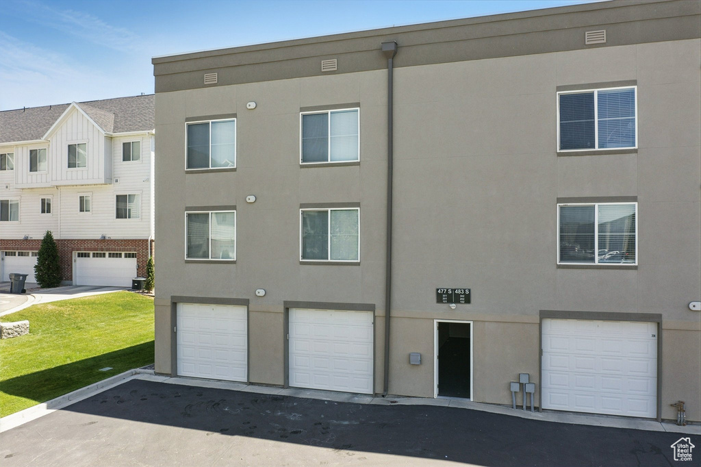 View of building exterior featuring an attached garage