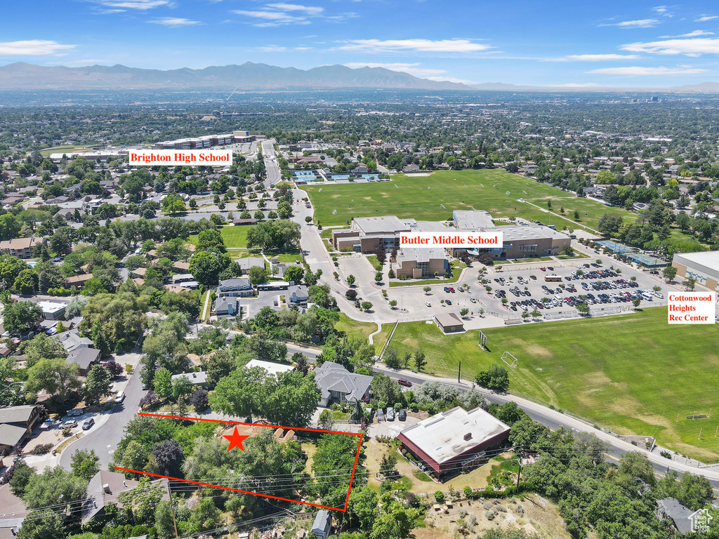 Aerial view of property and surrounding area with property parcel outlined and mountains