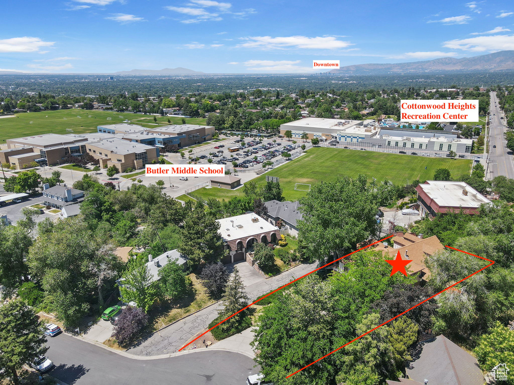 Aerial overview of property\\\'s location with property boundaries highlighted and a mountainous background
