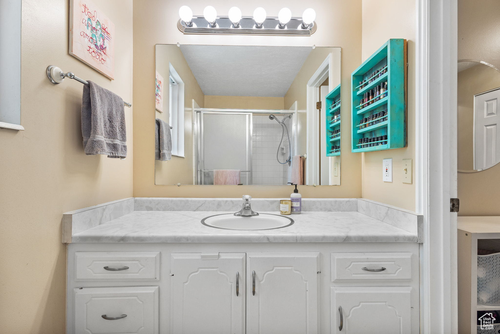 Bathroom with vanity and a stall shower