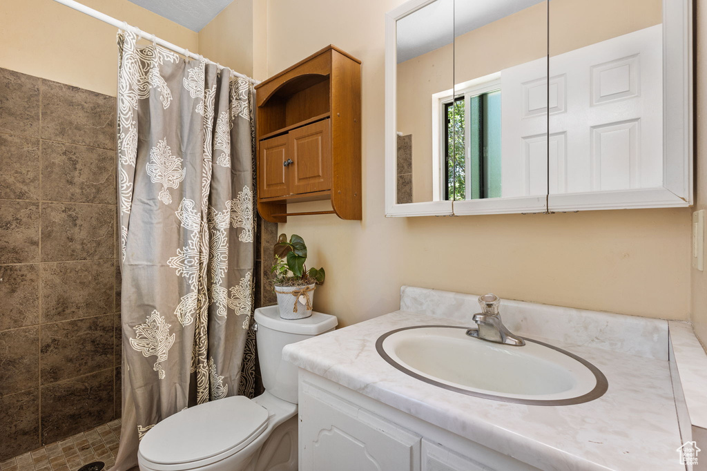 Bathroom featuring vanity and tiled shower