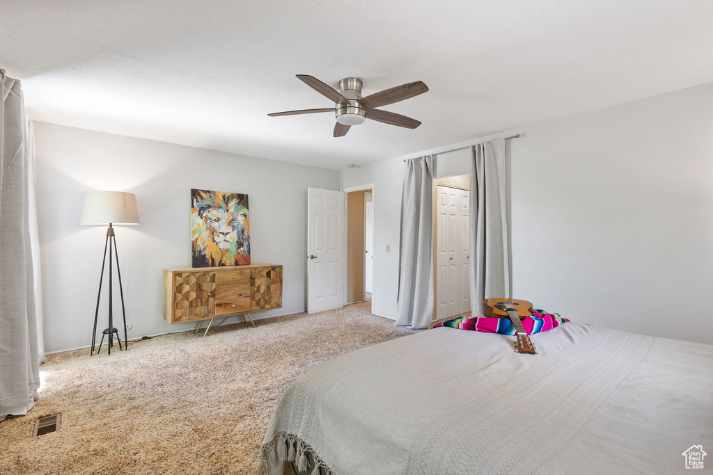 Carpeted bedroom with ceiling fan