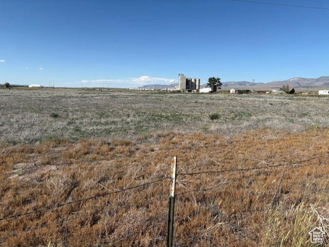 View of yard featuring a view of rural / pastoral area and a mountain view
