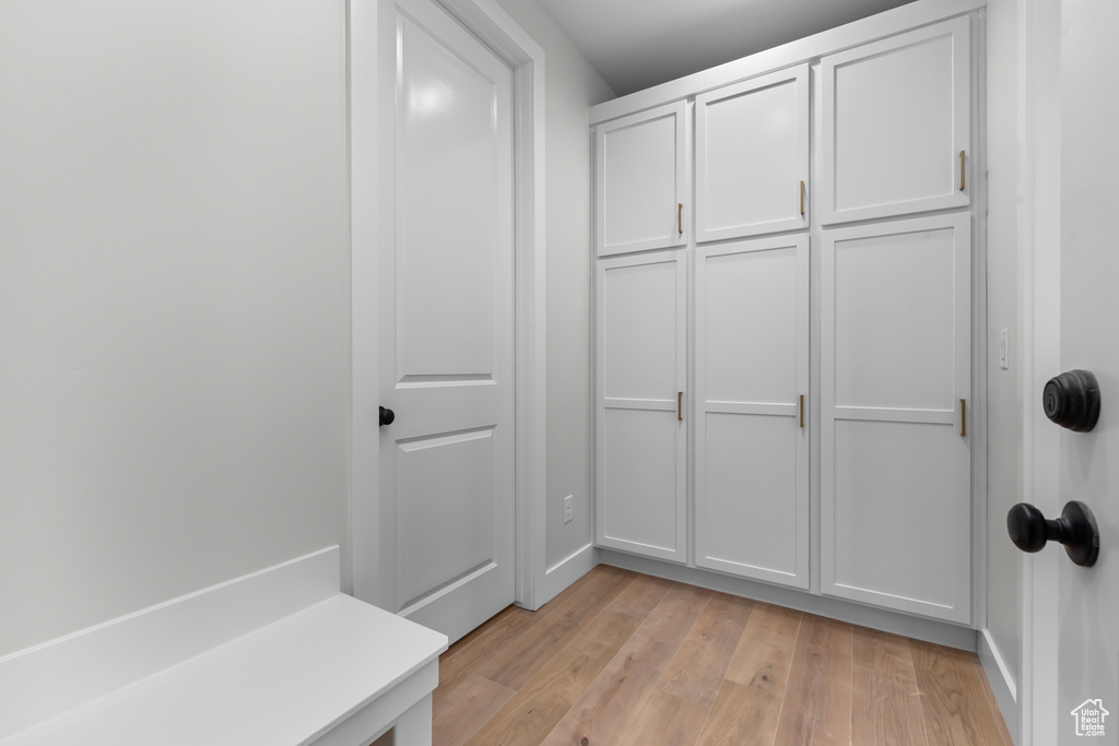 Mudroom with light wood-type flooring and baseboards