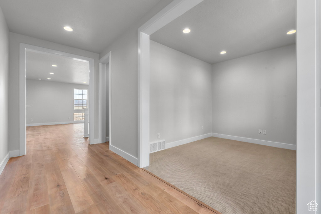 Empty room featuring recessed lighting and light wood-style floors