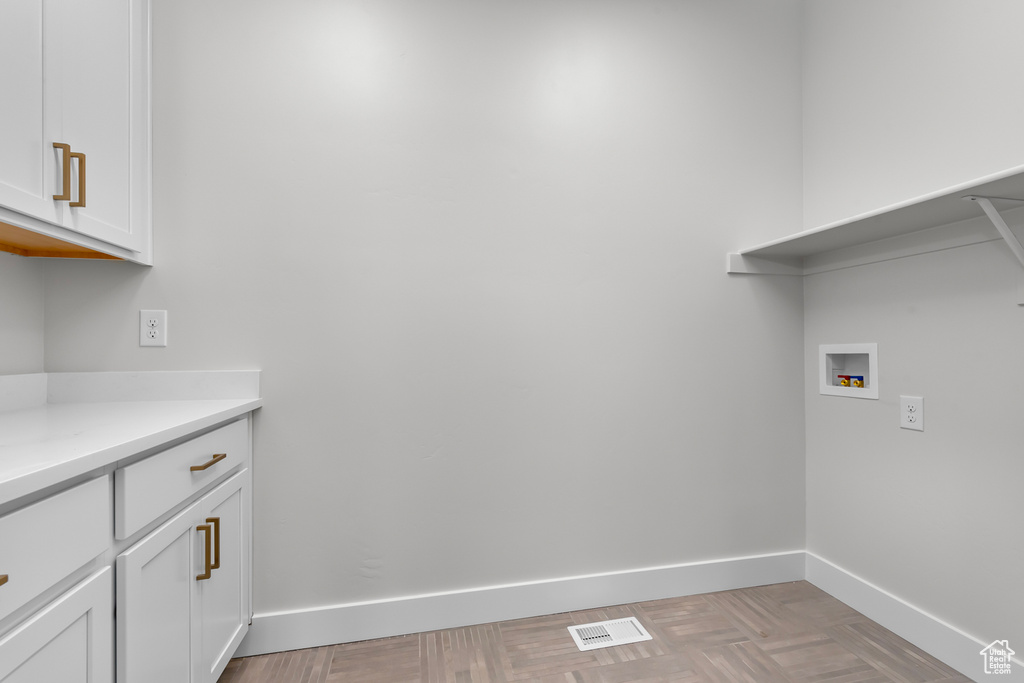 Laundry area with hookup for a washing machine and cabinet space