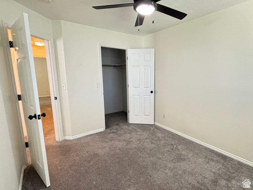 Unfurnished bedroom with carpet flooring, ceiling fan, and a closet