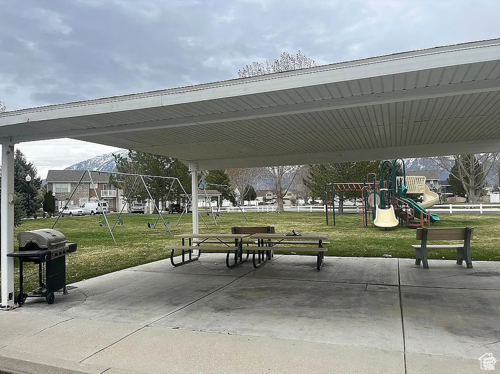 View of property\'s community with a playground and a yard
