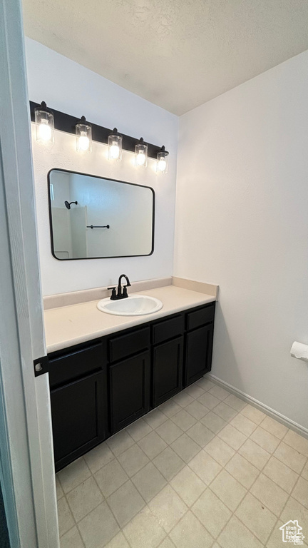 Bathroom with vanity and a textured ceiling