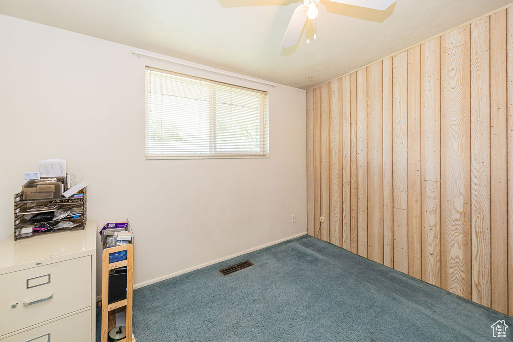 Carpeted bedroom featuring a ceiling fan