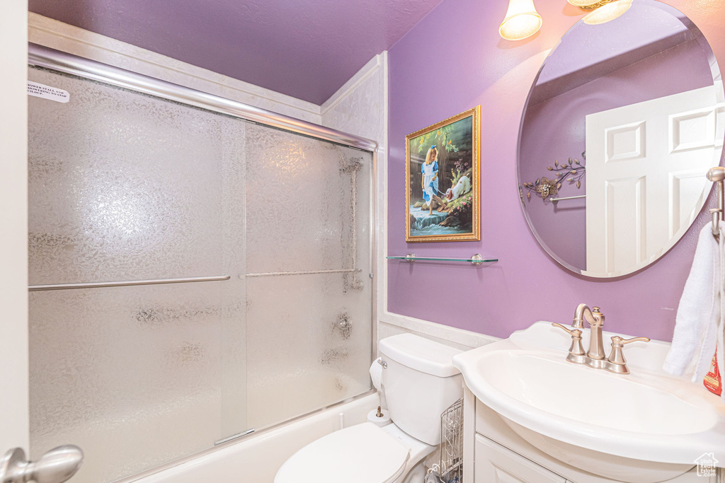 Full bath featuring vanity and enclosed tub / shower combo