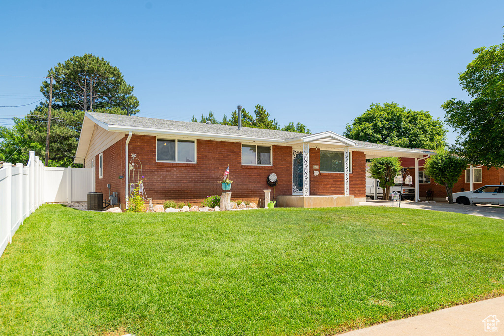 Ranch-style home featuring brick siding and a carport